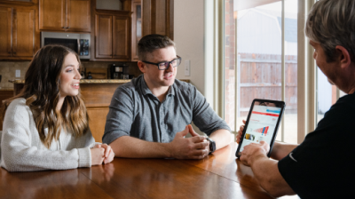 Customers discussing efficient solutions with an OG&E representative