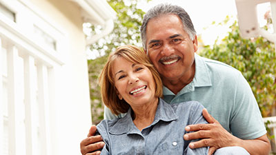 Older couple smiling outside