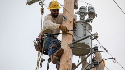 Lineman working on an electric line with safety gear