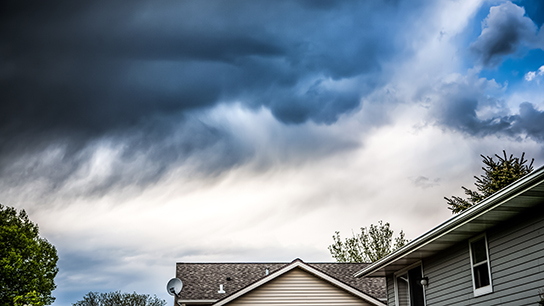 storm clouds coming over a home